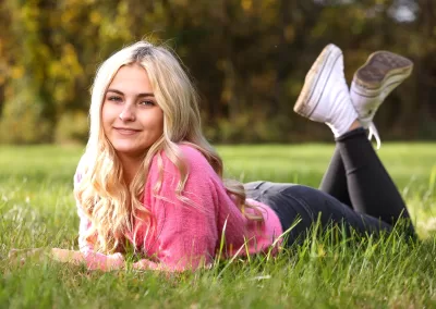 High School senior girl laying in the grass